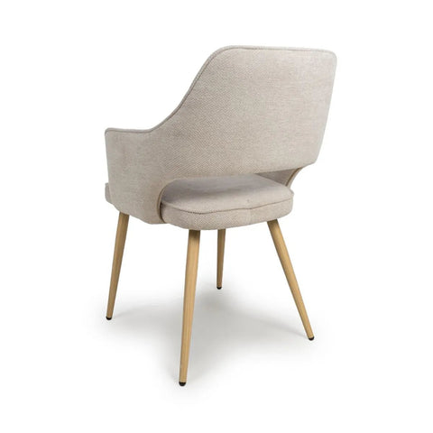 Angled Back view of Eaton modern dining armchairs in Natural fabric. Soft padded seat, light wood legs & ergonomic shape for comfort & style.