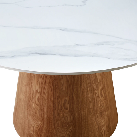 Round table with white marble sintered stone top and wooden base on a white background