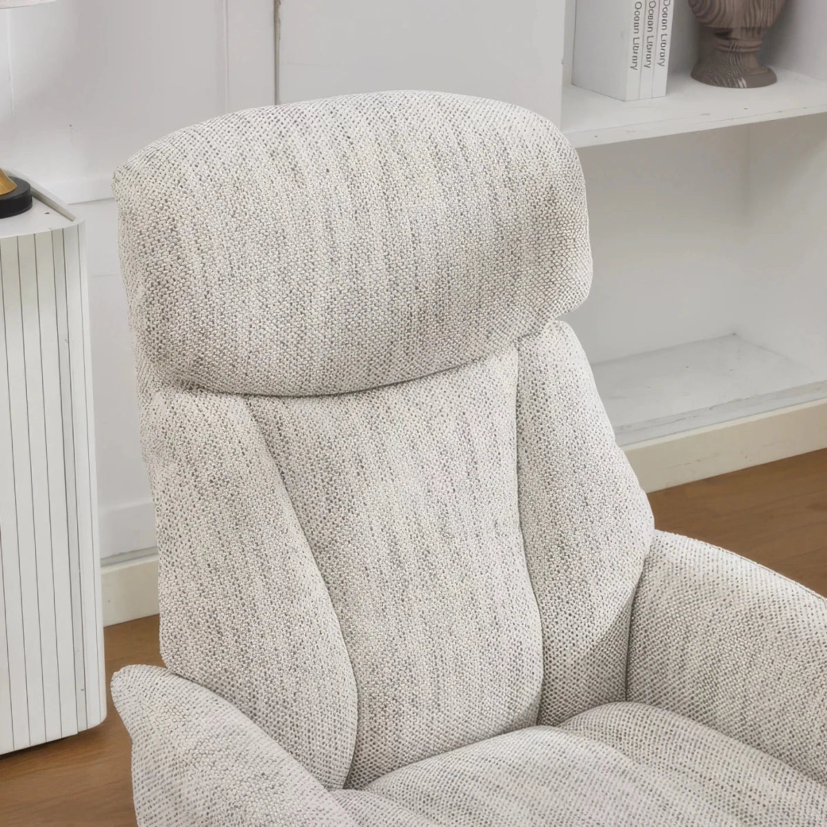 A close-up of a modern Elma fabric swivel recliner chair with footstool  High-back comfort, manual recline and 360° swivel action.