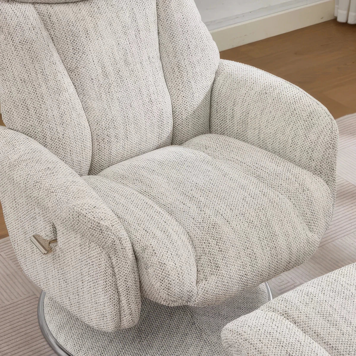 Seat close-up of a modern Elma fabric swivel recliner chair with footstool  High-back comfort, manual recline and 360° swivel action.