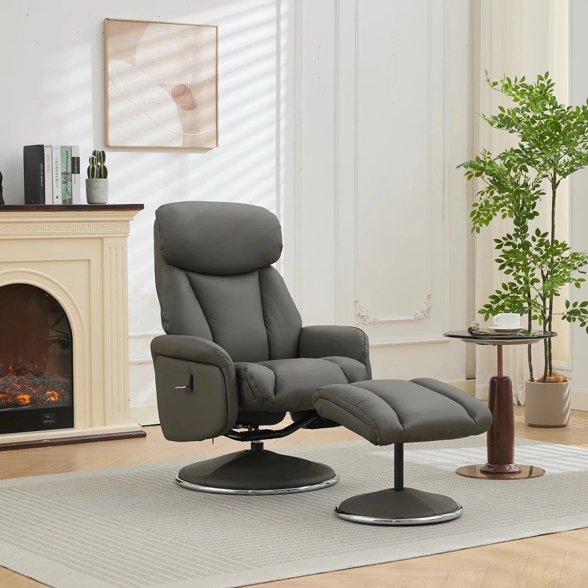 A modern gray upholstered recliner chair with a matching ottoman in a bright living room. The chair has a padded headrest, adjustable armrests, and a swivel base, with the ottoman placed in front.
