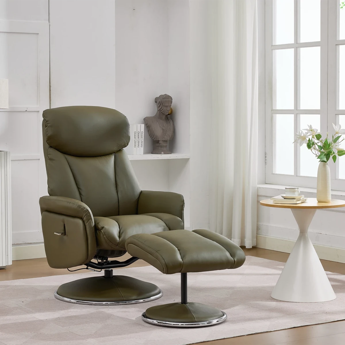An olive green leather recliner chair with a matching ottoman in a bright, modern living room setting.