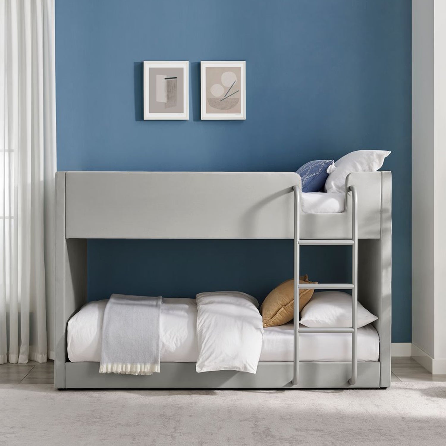 Lifestyle image of the Elodie Elite Bunk Bed upholstered in grey fabric with button detailing on the ends