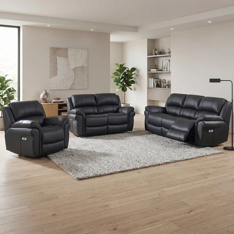 A three-piece Flynn black leather look Power reclining sofa set in a modern living room, including a recliner chair, a 2 seater, and a three-seater sofa arranged around a gray shag rug on light wood flooring.