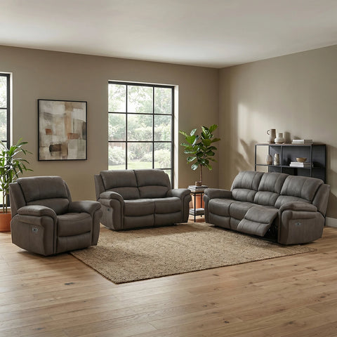 A 3-piece gray recliner furniture set in a modern living room, including a single armchair, a loveseat, and a larger three-seater sofa, arranged around a central area rug on a wood floor.