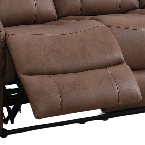 Close-up of a brown faux leather reclining sofa showing the extended footrest and padded armrests with stitching details.