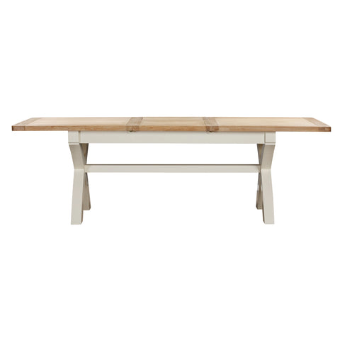A Foxington Dining table with a light natural wood top and a cream-colored frame, shown against a plain white background.