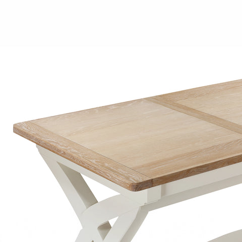 Close-up of a Foxington light oak wood extendable table top with a white painted frame, showing the grain and joint detail against a white background.
