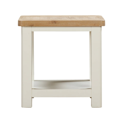A close up of small Foxington Lamp Table with a light natural oak wood top, off-white painted frame and lower shelf. Shown against a plain white background.