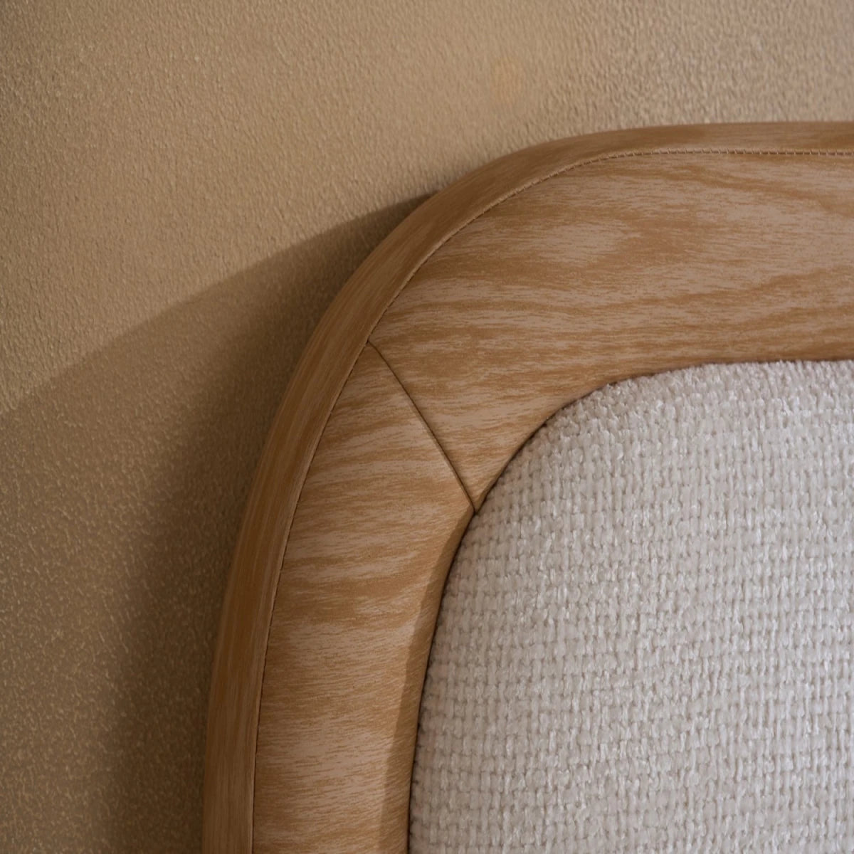 Softly curved padded headboard with upholstered fabric finish.