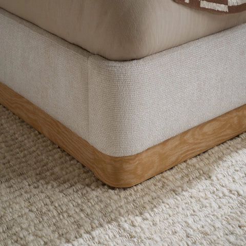 Fabric upholstered with smooth curves and soft padding.