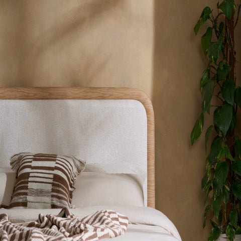 Fabric upholstered headboard with smooth curves and soft padding.