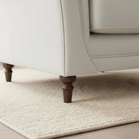 Stylish dark wooden feet adding timeless character to the sofa.