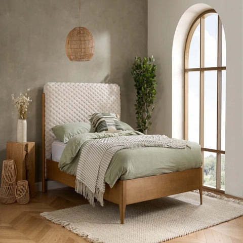 Contemporary bed with plush faux fur texture and natural wood base.