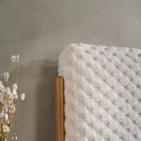 Upholstered headboard with luxurious faux fur fabric.