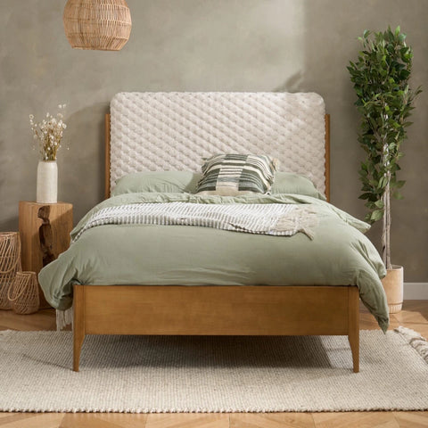 Contemporary bed with plush faux fur texture and natural wood base.