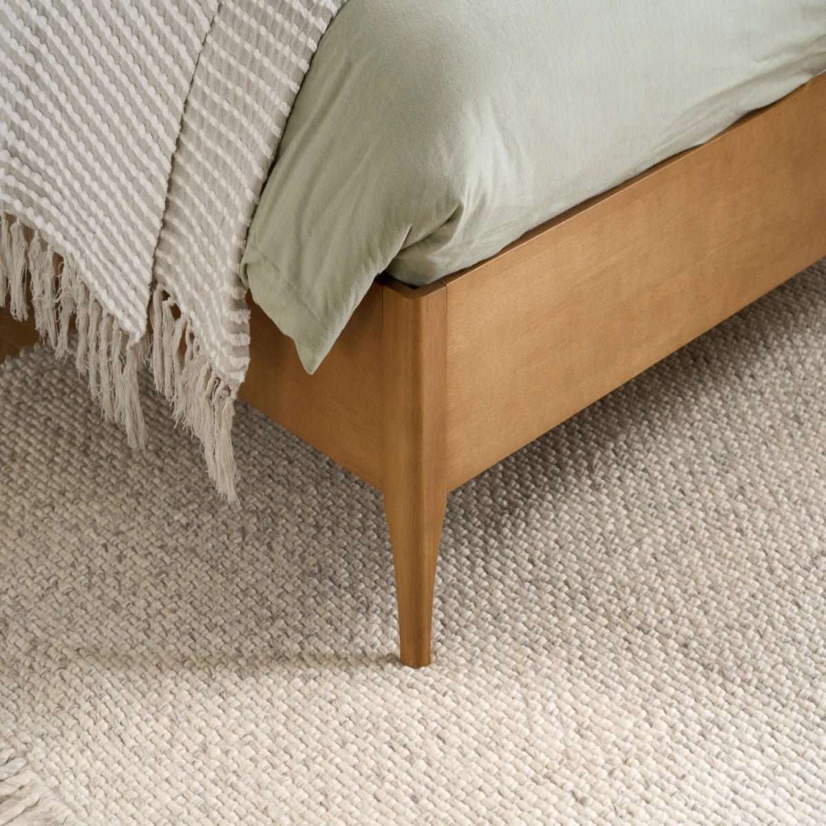 Natural wood legs ensuring reliable base support and durability.