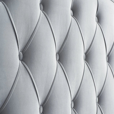 Tall wingback headboard with elegant tufted detailing.