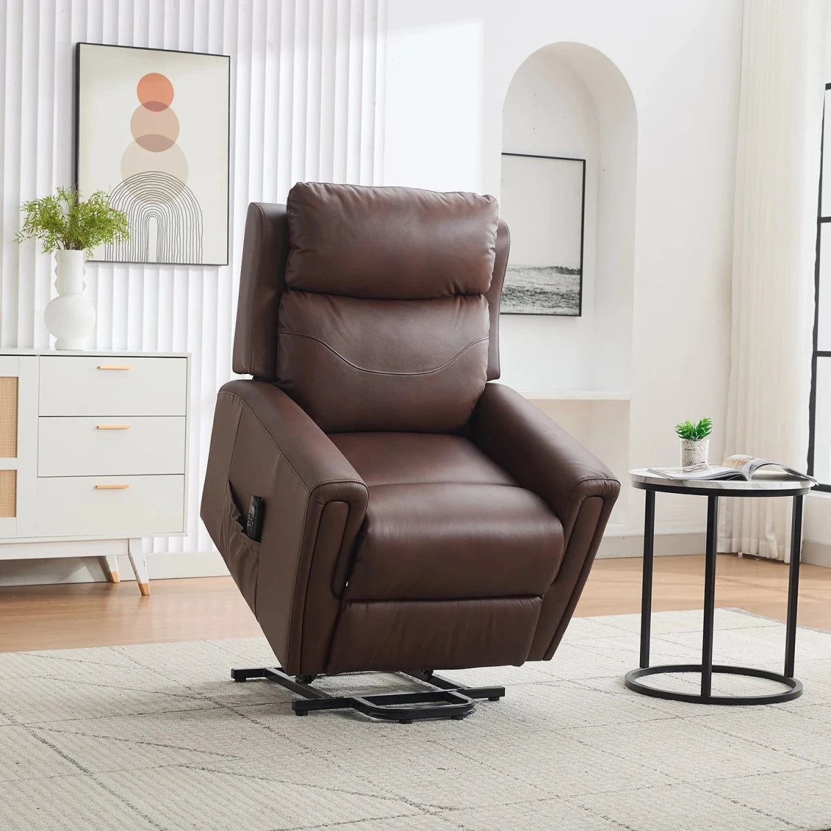 A brown leather dual motor riser recliner chair with a black swivel base, shown in a modern, bright living room setting