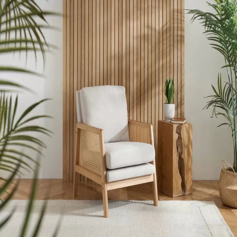 Modern armchair with rattan sides and soft cushions.