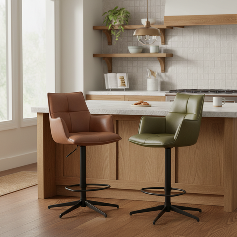 Two modern swivel bar stools in a bright kitchen setting: one in Rust orange PU leather and one in olive green leather, both with black metal star bases.
