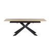 A modern rectangular dining table with a light natural wood top and a black metal X-shaped base, shown against a plain white background.