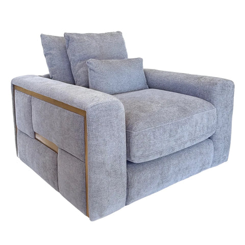 A modern low-profile armchair upholstered in textured light gray fabric, featuring a square frame with gold trim and three matching back cushions, shown on a plain white background.