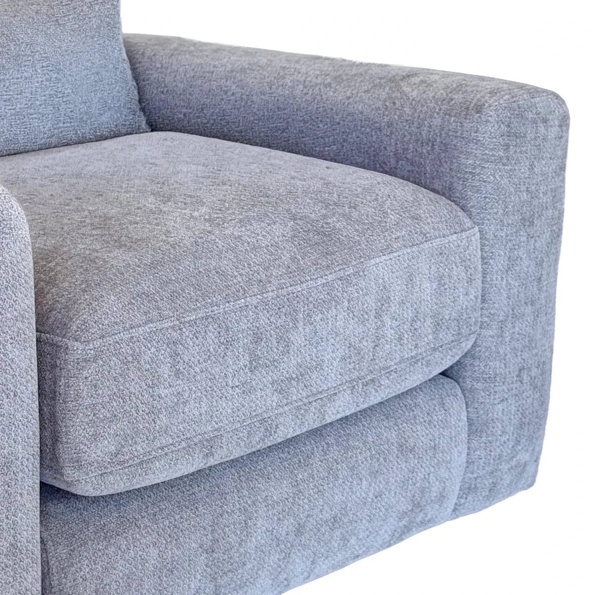 Close-up of a light gray textured fabric armchair showing the seat cushion, armrest, and side bolster against a white background.