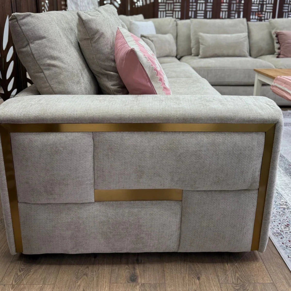 Soft high-quality beige fabric corner sofa with smooth finish.