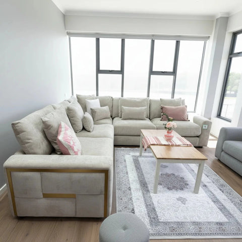 Beige large corner sofa with deep seating and scatter cushions.