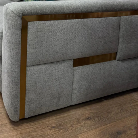 Modern grey corner sofa with elegant armrest detailing.