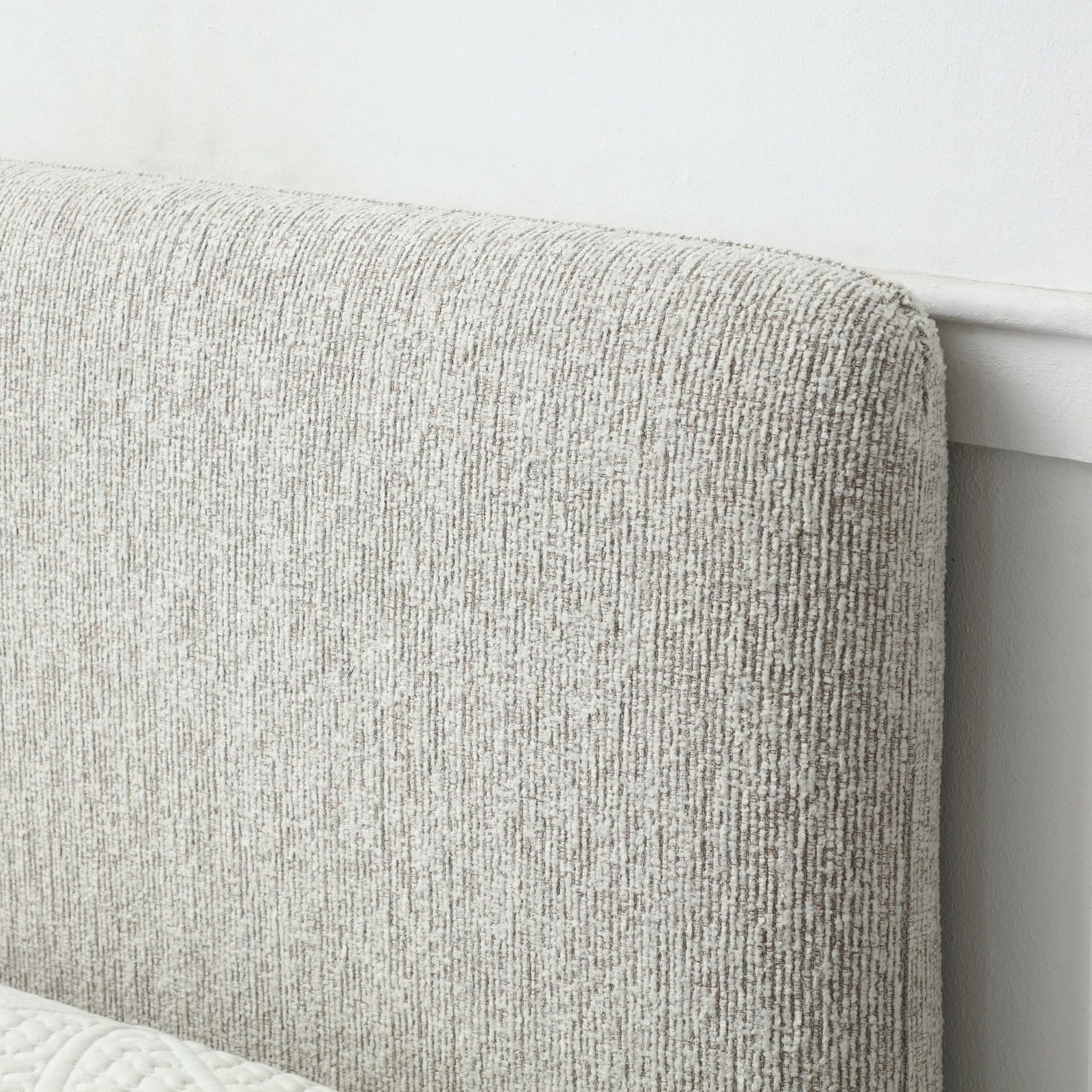 Close up of Headboard of Natural Upholstered Bed with End Opening Ottoman Storage