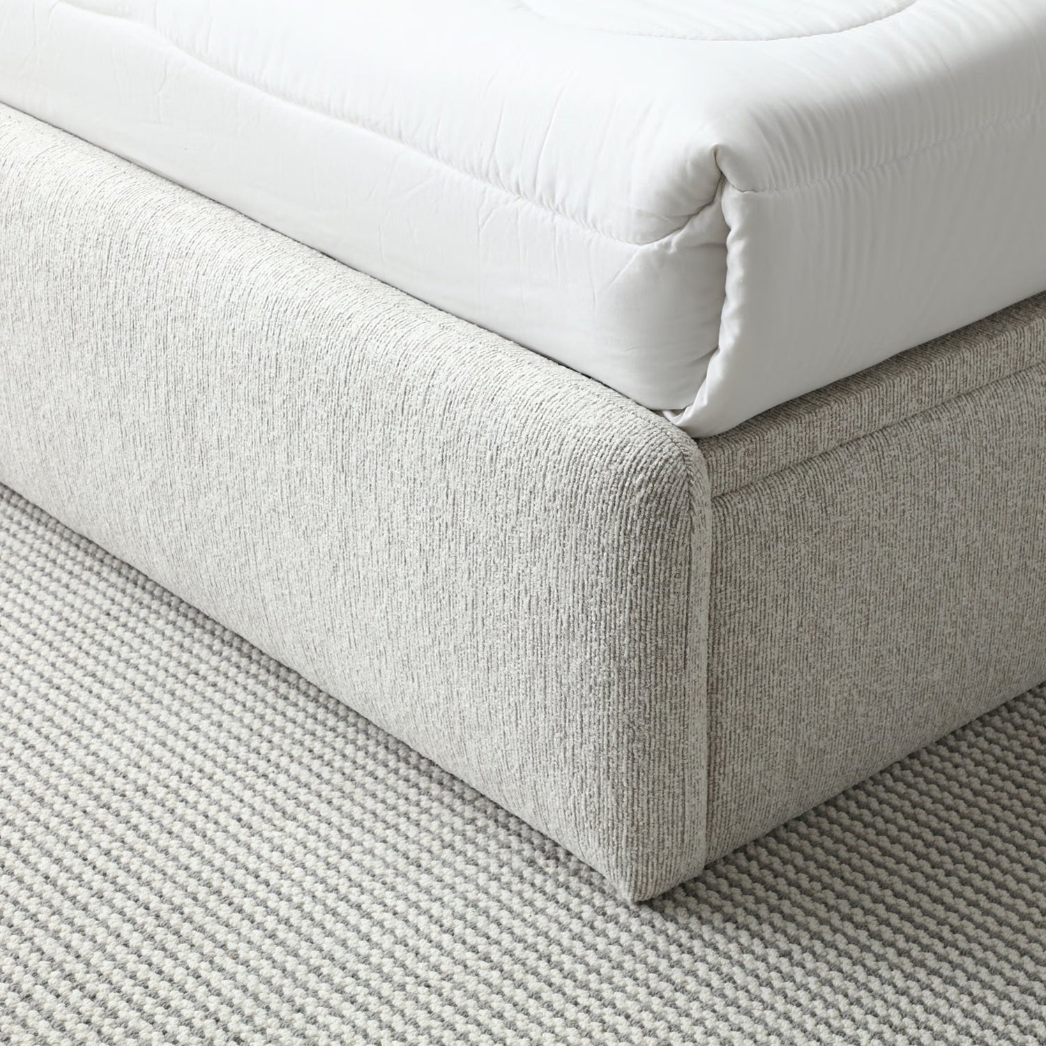 Closeup of Natural Upholstered Bed with End Opening Ottoman Storage, showing footend