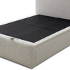 Natural Upholstered Bed with End Opening Ottoman Storage with a black mattress or mattress topper on a white studio background.
