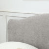 Close-up of a light gray upholstered headboard of Usher  Fabric Upholstered End Lift Ottoman Bed with Curved Headboard