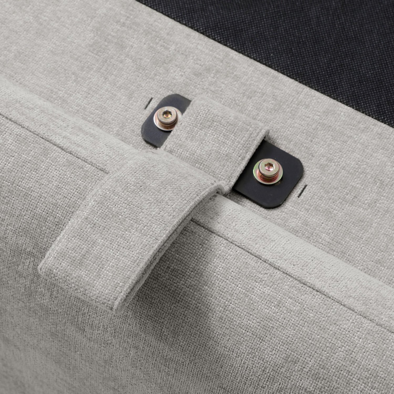 Close-up of a gray fabric handle of Usher Grey Chenille Ottoman Storage Bed with Curved Headboard
