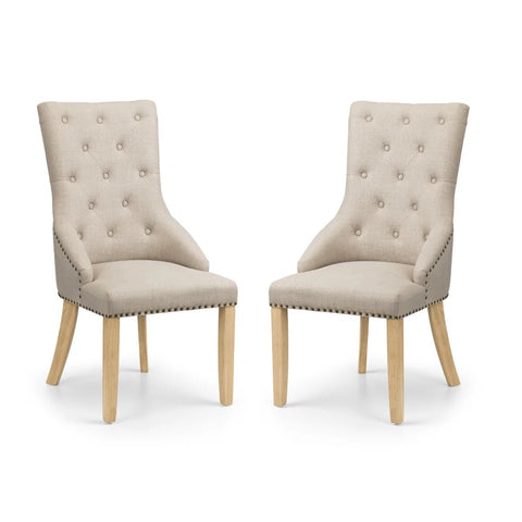 Two beige upholstered chairs with wooden legs on a white background