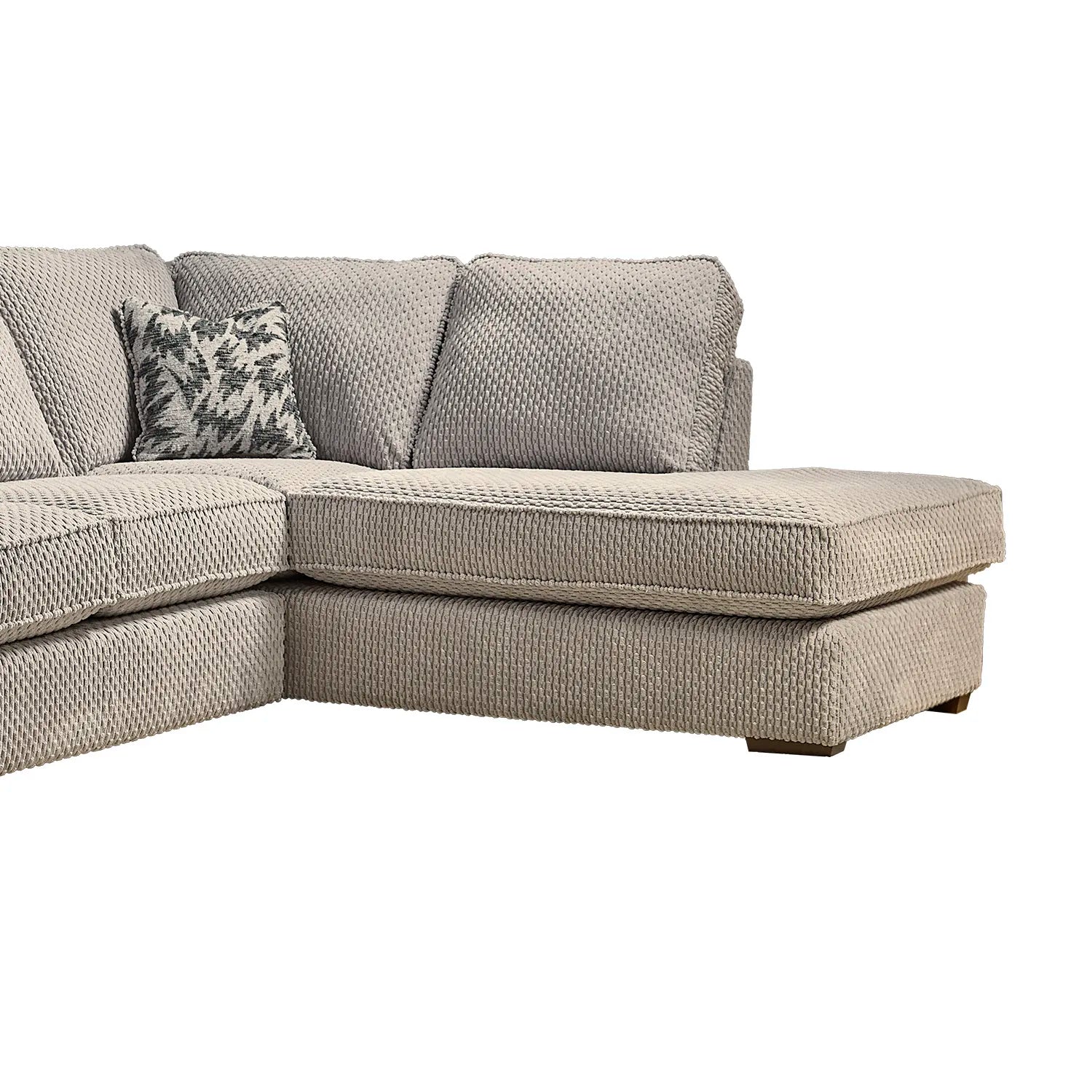 Gray sectional sofa with a patterned pillow on a white background