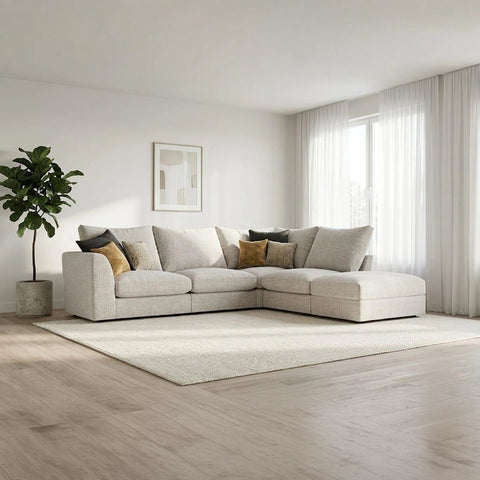 Modern modular fabric sofa with deep cushions, neutral upholstery, and a coordinating stool for added comfort