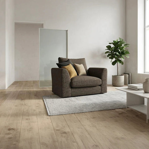 Stylish fabric armchair with deep plush cushioning, neutral upholstery, and a sleek modern silhouette