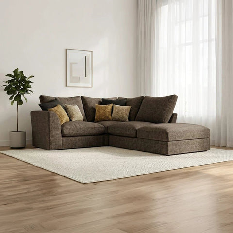 Modern modular fabric sofa with deep cushions, neutral upholstery, and a matching stool