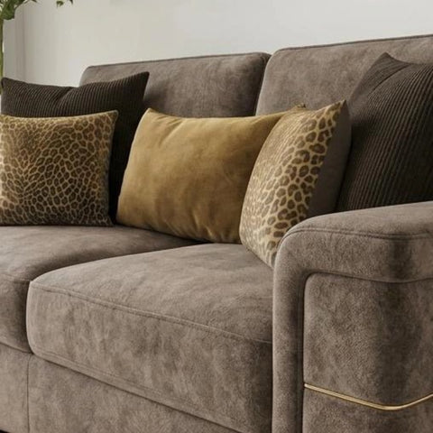 Velvet sofa with plush cushions, soft dappled fabric.