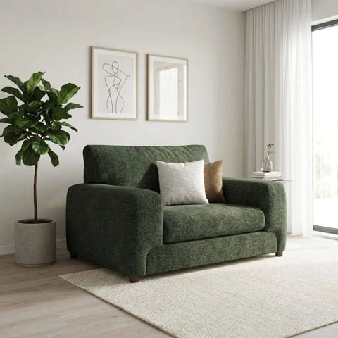 Compact green fabric love chair with deep cushioning.