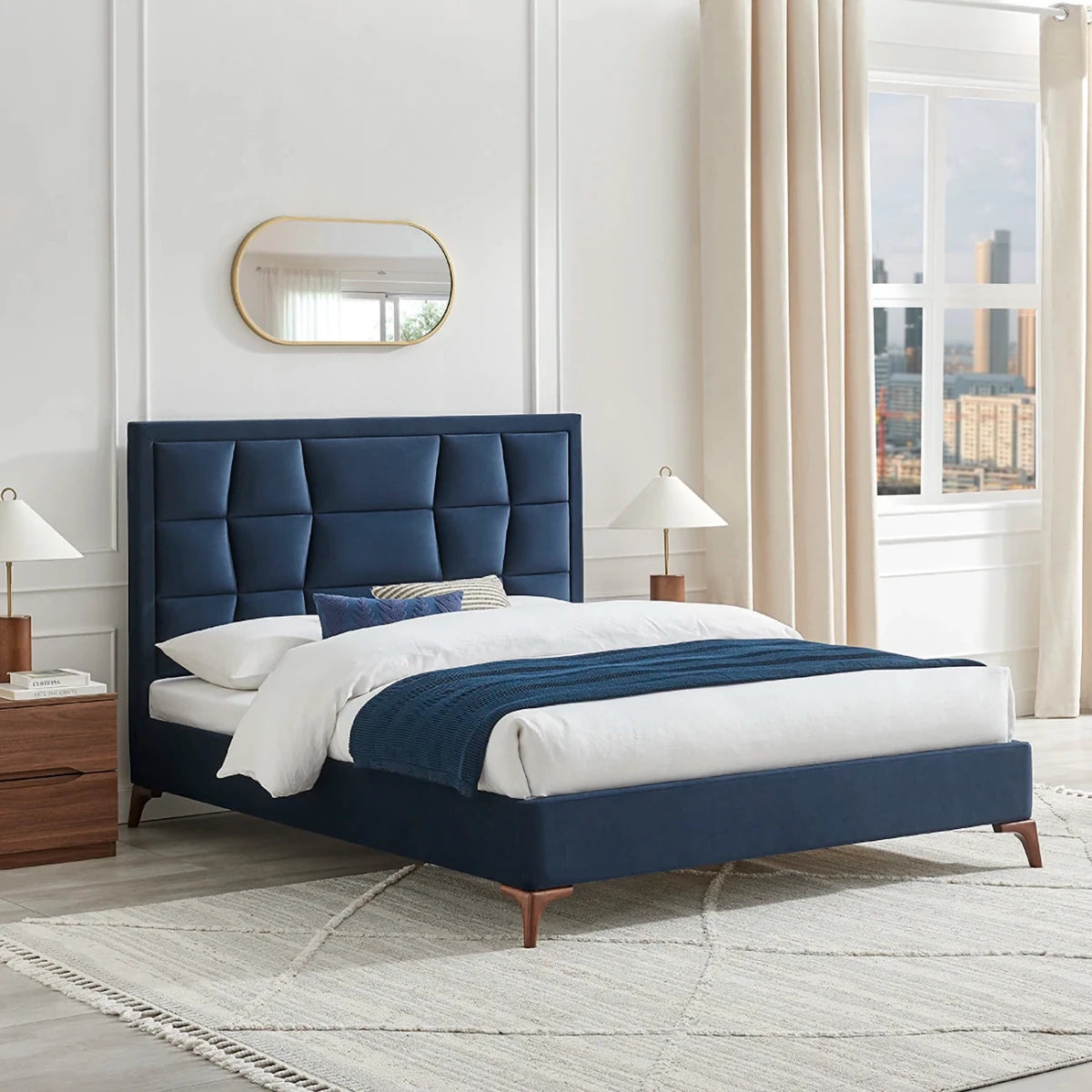 Lifestyle image of the Camila Luxury Bed shown in Navy Velvet. Also available in Natural or Grey in a choice of 3 sizes, Double, Kingsize or Superking.