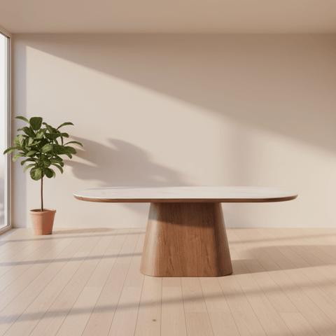 Modern dining table with a wooden base in a bright room with large windows.