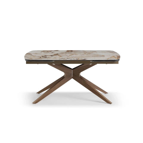 Dining table with ceramic top and wooden legs on a white background