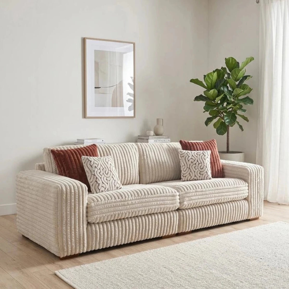 Modern 4 seater sofa with soft cord fabric, wooden feet, and stylish cushions.