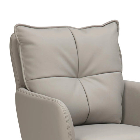 Close-up of a light beige upholstered chair with a large segmented back cushion and visible contrast stitching, shown against a plain white background.