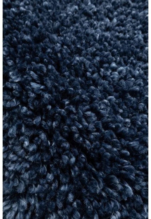 Shaggy rug close-up showing deep pile and soft blue fibers.