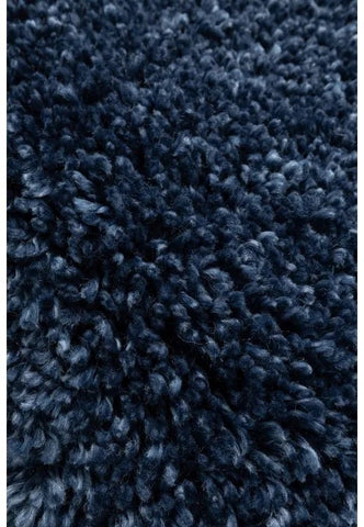 Shaggy rug close-up showing deep pile and soft blue fibers.